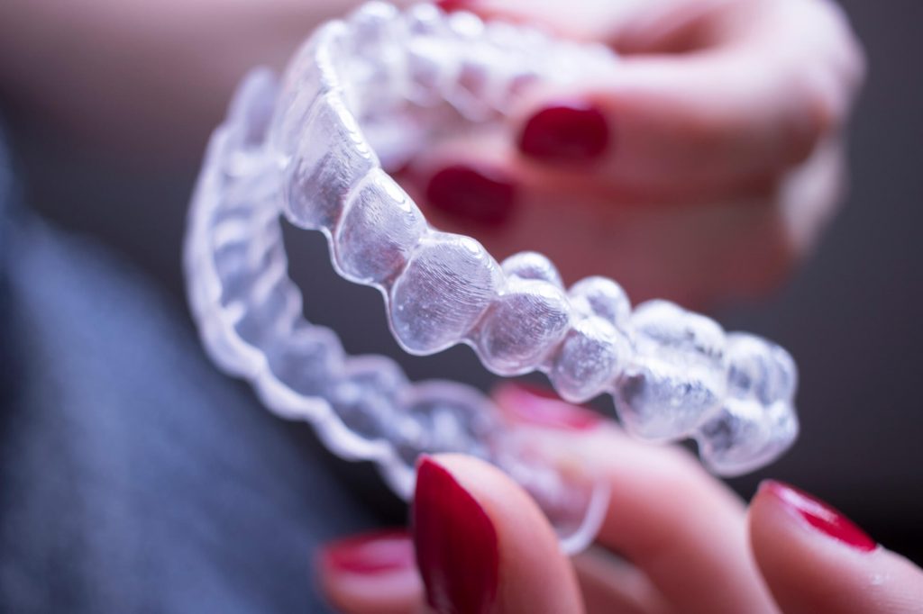 woman holding invisible braces in Ladysmith