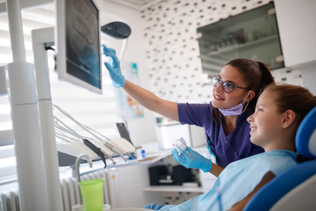 Dentist showing patient xray for Teeth Straightening Ladysmith