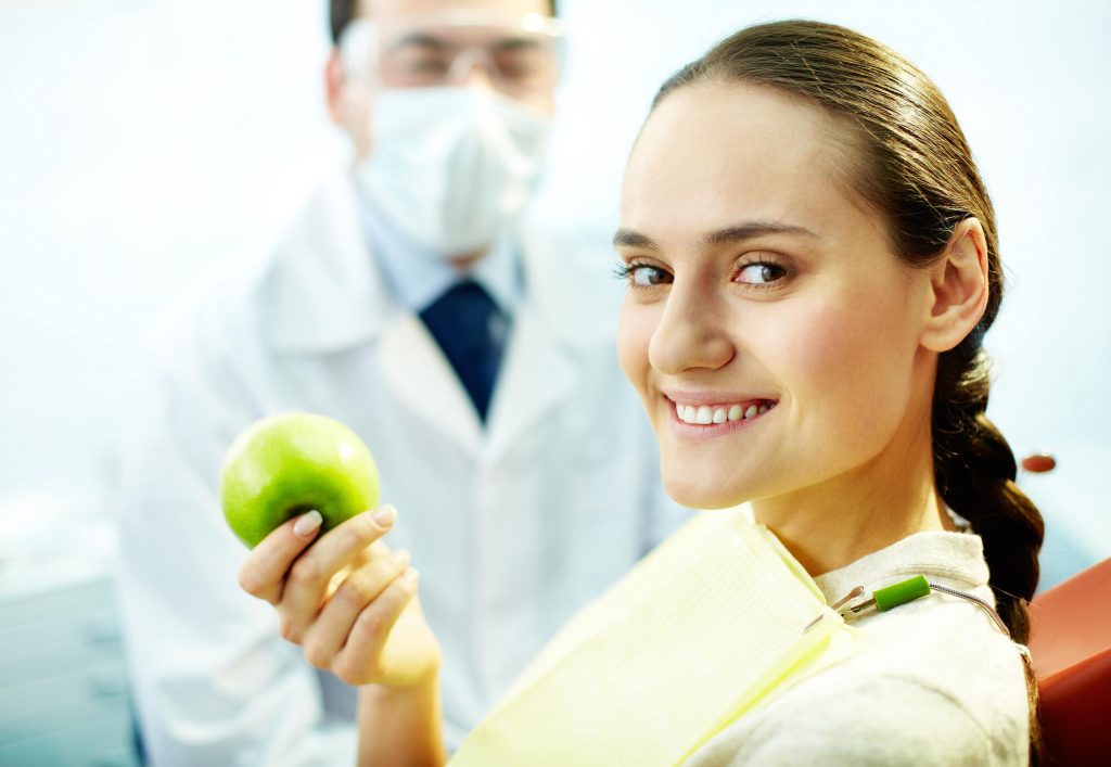 woman with apple Dentist Office Medford