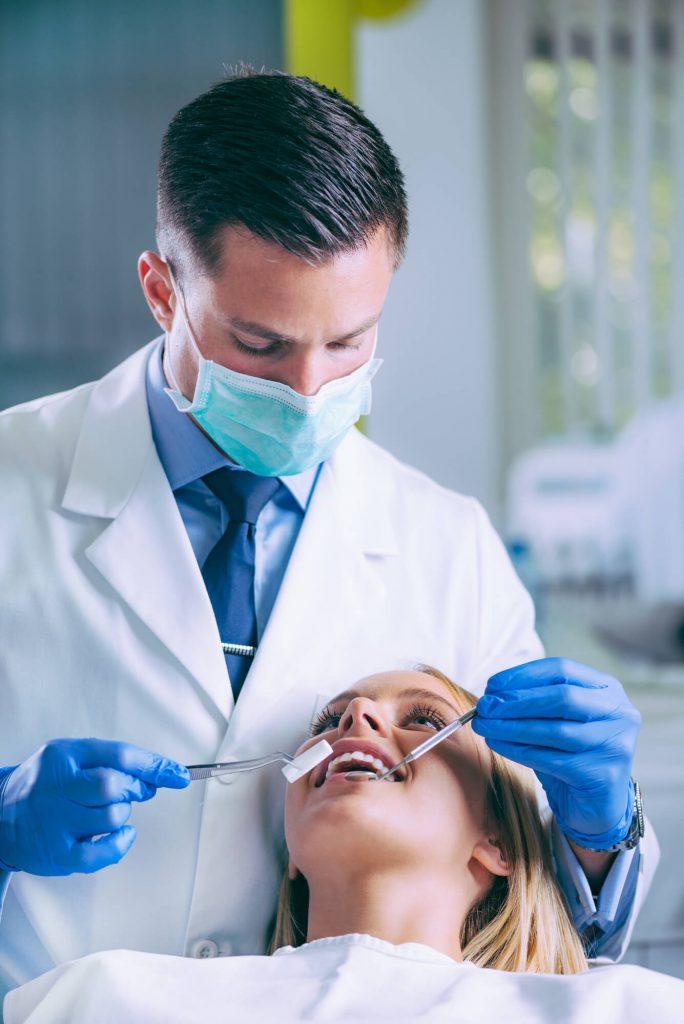 dentist working to perform dental bonding in Phillips
