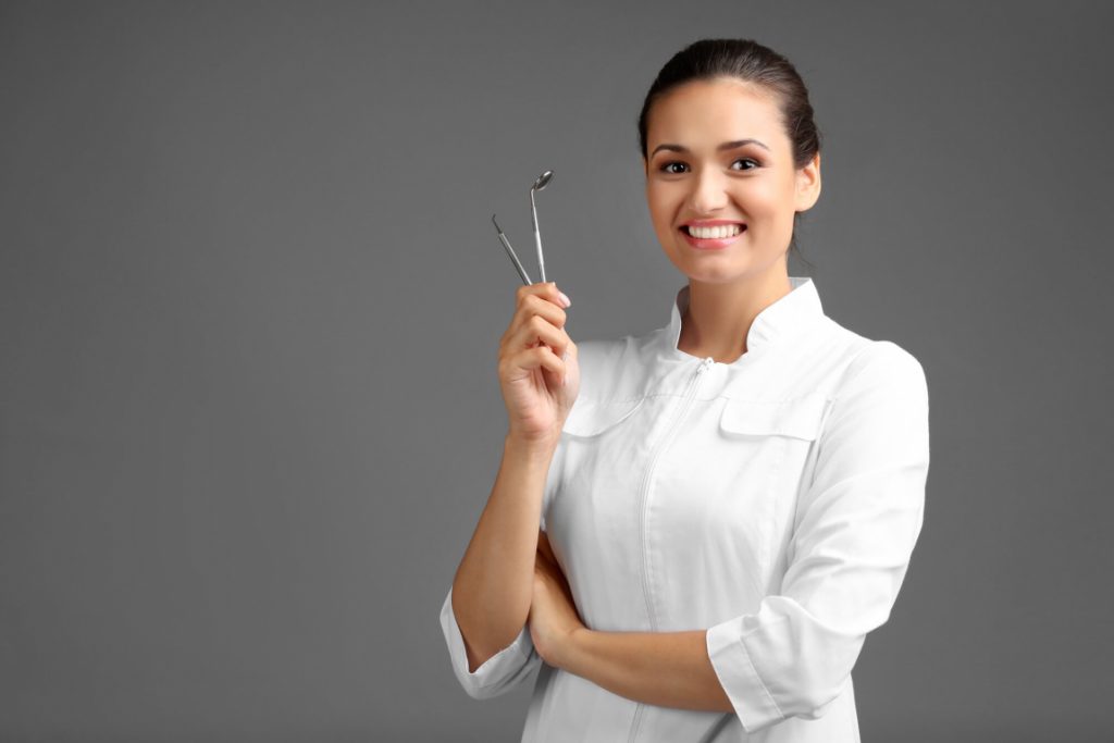 dentist holds dental tools for teeth straightening in Ladysmith