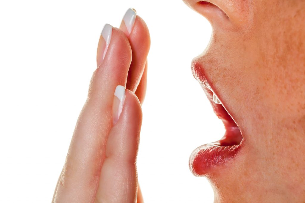 a woman with stinky breath needing affordable dental in medford