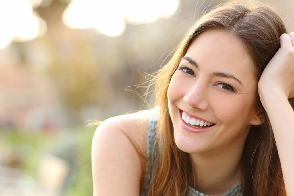 girl smiling outside after getting brite smile treatment in phillips