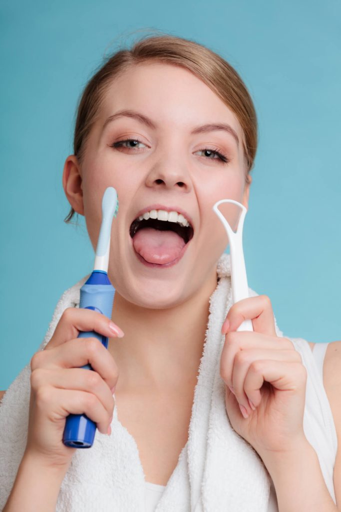 woman holding brushes in dentist office in Medford 