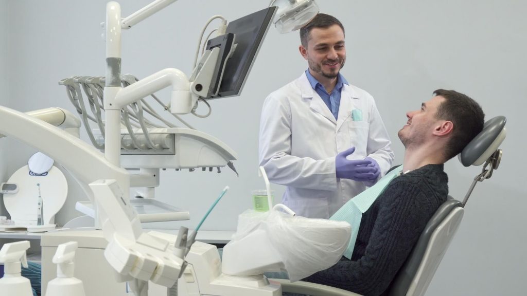 a dentist discussing phillips oral cancer screening