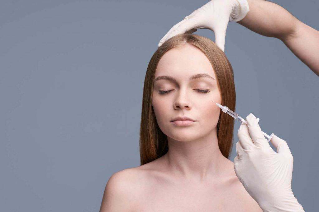 a beautiful woman receiving juvederm treatment in park falls