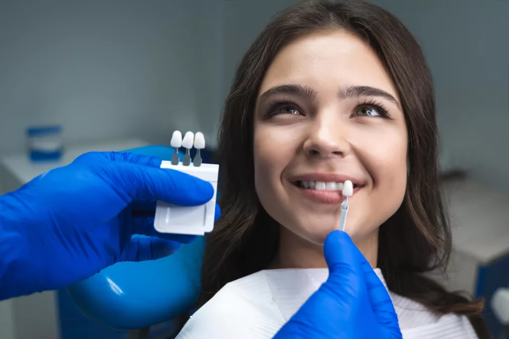 A patient choosing the shade for her teeth for her cosmetic dentistry procedure in Medford