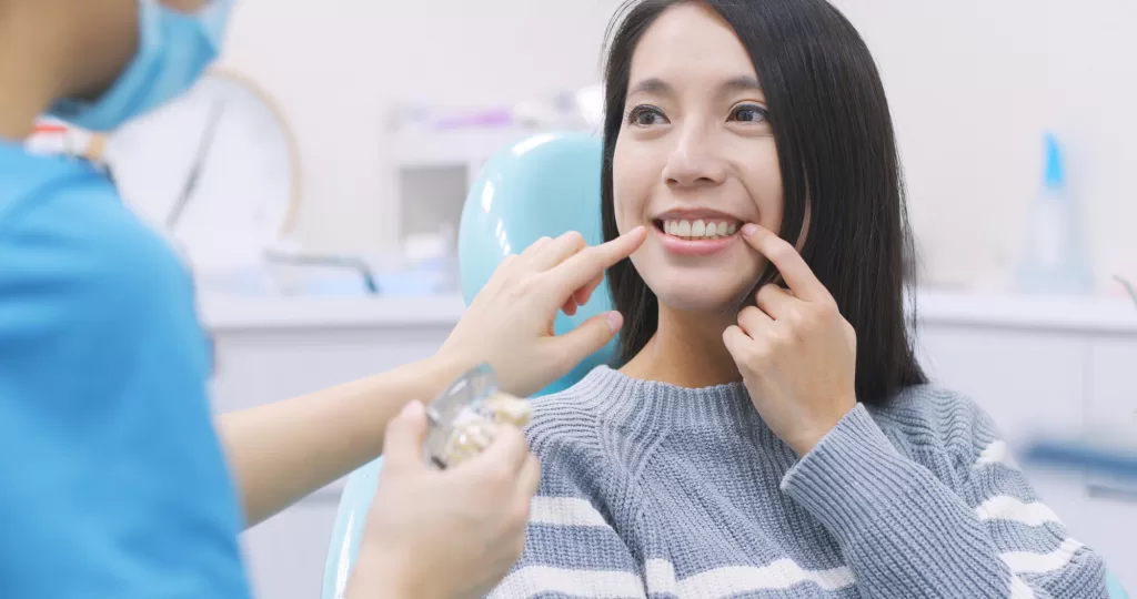 Woman at a dentist having her dental implants in Medford checked