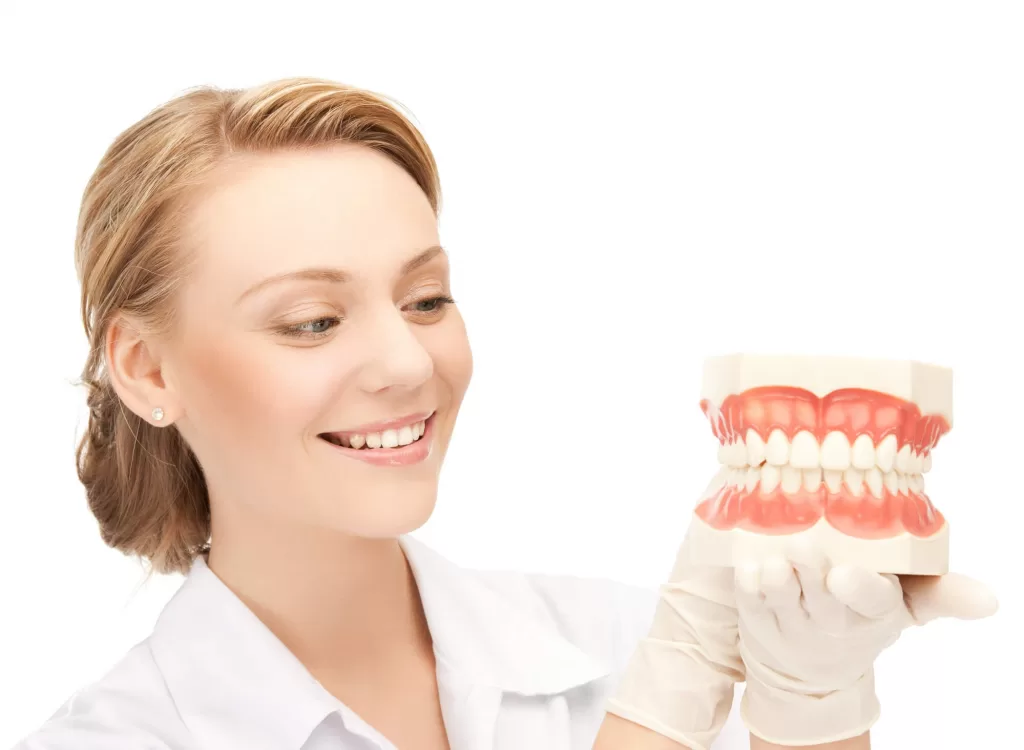 dentist holding a big model of dentures in ladysmith