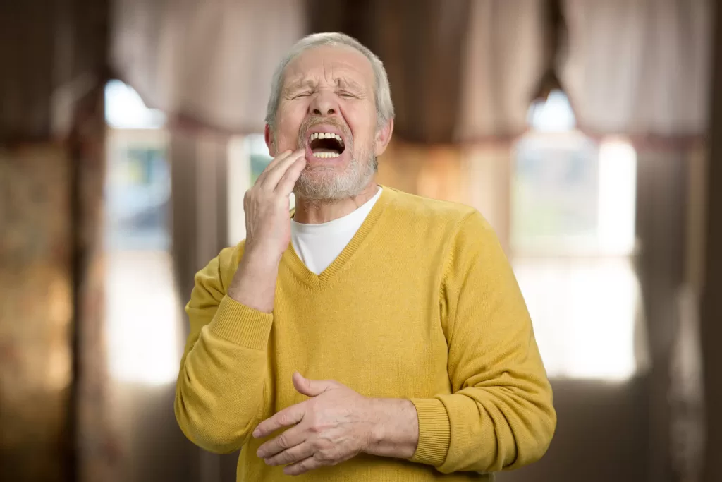elderly man with toothache during an emergency dental in medford