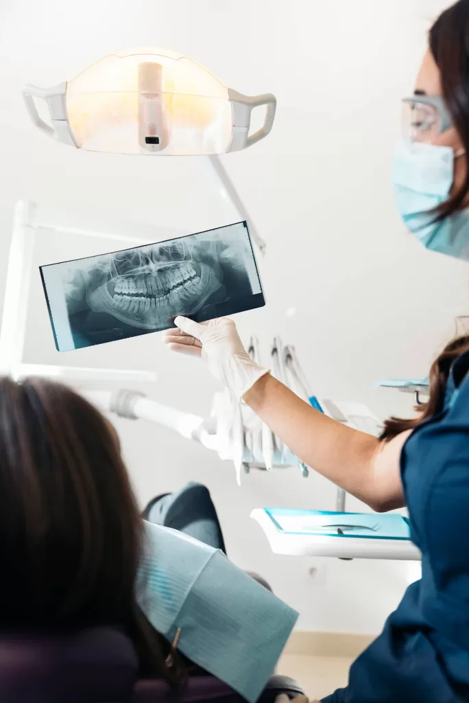 oral surgeon medford showing patient an X-ray image